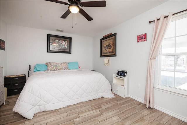 bedroom featuring multiple windows and ceiling fan