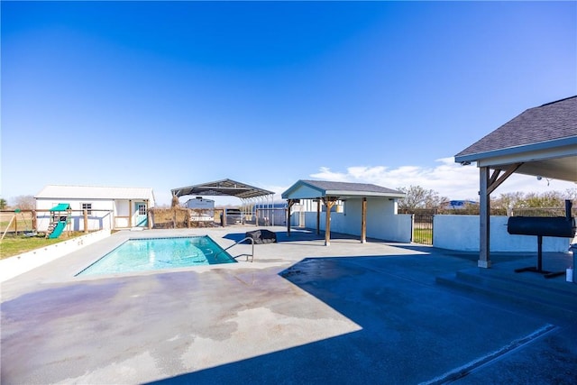 view of swimming pool with an outbuilding, a patio, fence, a gazebo, and a fenced in pool