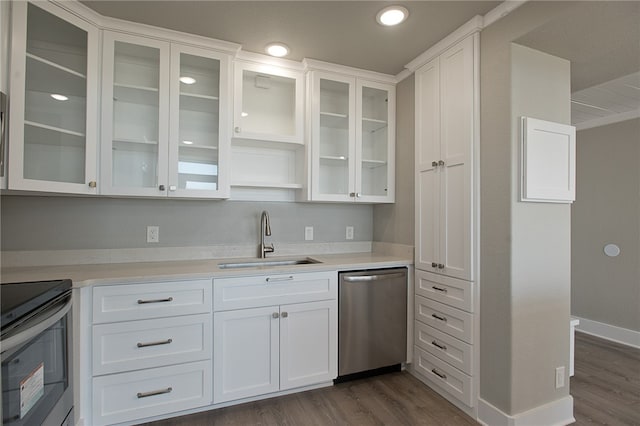 kitchen featuring stainless steel appliances, white cabinets, sink, and dark hardwood / wood-style flooring