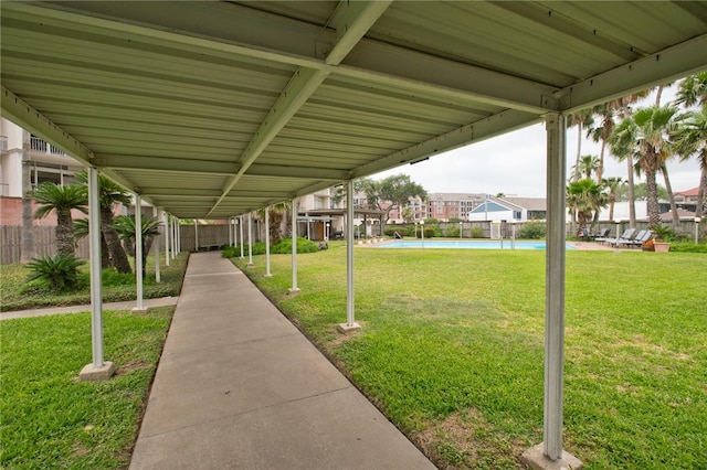 view of home's community with a swimming pool and a lawn