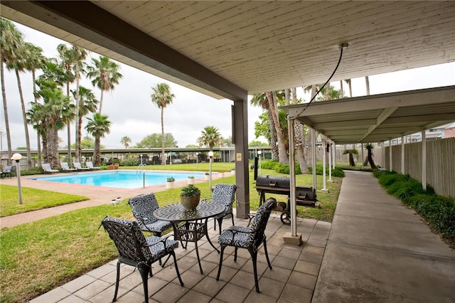 view of patio with a fenced in pool