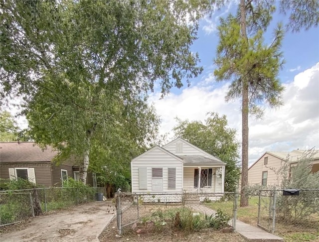 bungalow-style home featuring a fenced front yard and a gate