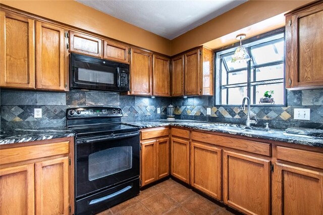 2725 Persimmon St, Corpus Christi, TX 78415 - kitchen featuring black appliances, brown cabinets, and a sink