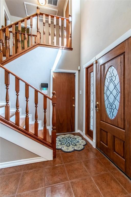 2725 Persimmon St, Corpus Christi, TX 78415 - foyer entrance with stairway, tile patterned floors, and a high ceiling