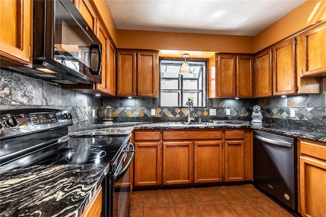 2725 Persimmon St, Corpus Christi, TX 78415 - kitchen featuring black appliances, tasteful backsplash, brown cabinets, dark stone counters, and dark tile patterned floors