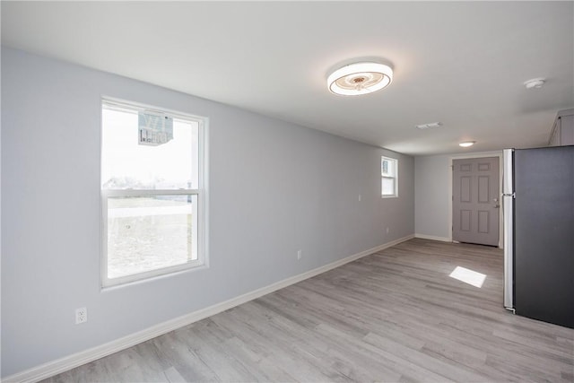 unfurnished room with light wood-type flooring