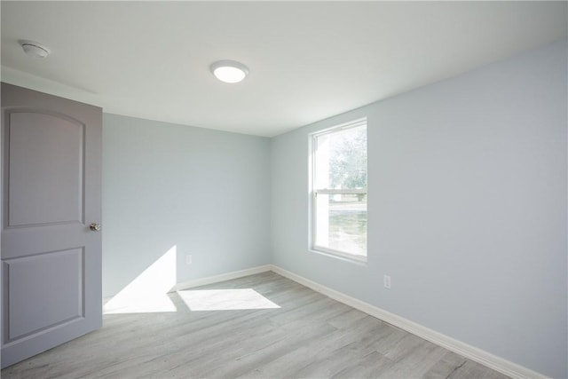 unfurnished room with light wood-type flooring