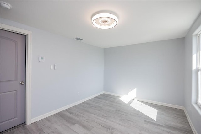 empty room with light hardwood / wood-style flooring