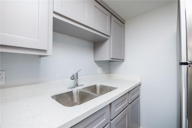 kitchen with gray cabinetry and sink