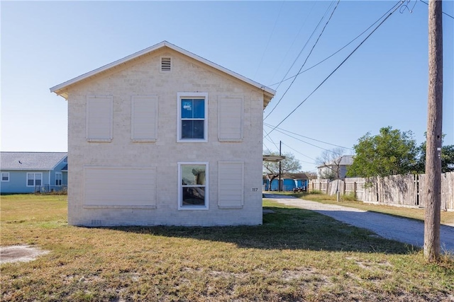 rear view of property with a yard