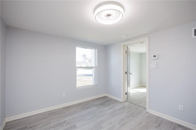 unfurnished room featuring light hardwood / wood-style flooring