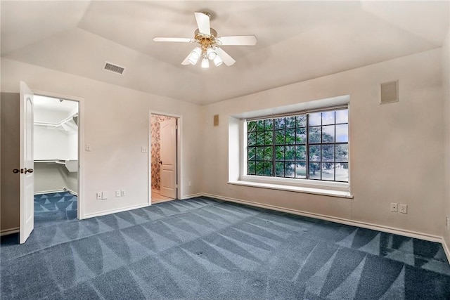 6714 Long Meadow Dr, Corpus Christi, TX 78413 - unfurnished bedroom featuring dark colored carpet, a spacious closet, and ceiling fan