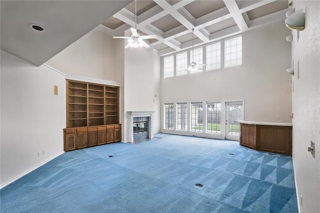 6714 Long Meadow Dr, Corpus Christi, TX 78413 - unfurnished living room with ceiling fan, a towering ceiling, beamed ceiling, a fireplace, and carpet floors