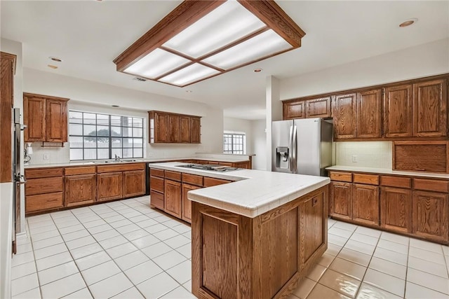 6714 Long Meadow Dr, Corpus Christi, TX 78413 - kitchen featuring stainless steel fridge with ice dispenser, light tile patterned flooring, tasteful backsplash, gas cooktop, and recessed lighting