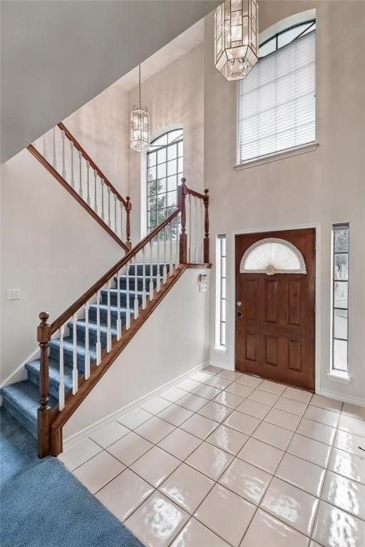 6714 Long Meadow Dr, Corpus Christi, TX 78413 - tiled entrance foyer with a high ceiling, a chandelier, and stairway