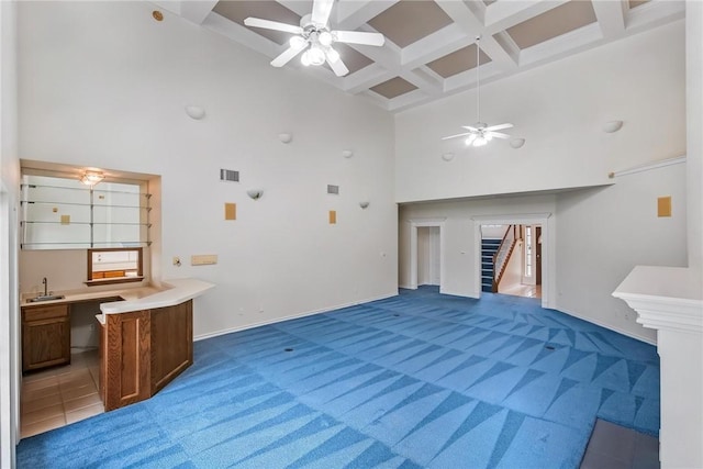 6714 Long Meadow Dr, Corpus Christi, TX 78413 - unfurnished living room with a high ceiling, coffered ceiling, ceiling fan, stairway, and light colored carpet