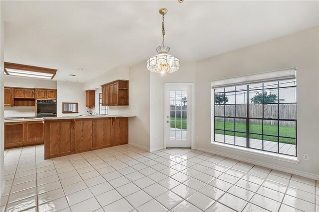 6714 Long Meadow Dr, Corpus Christi, TX 78413 - kitchen featuring oven, brown cabinetry, light countertops, open shelves, and a chandelier