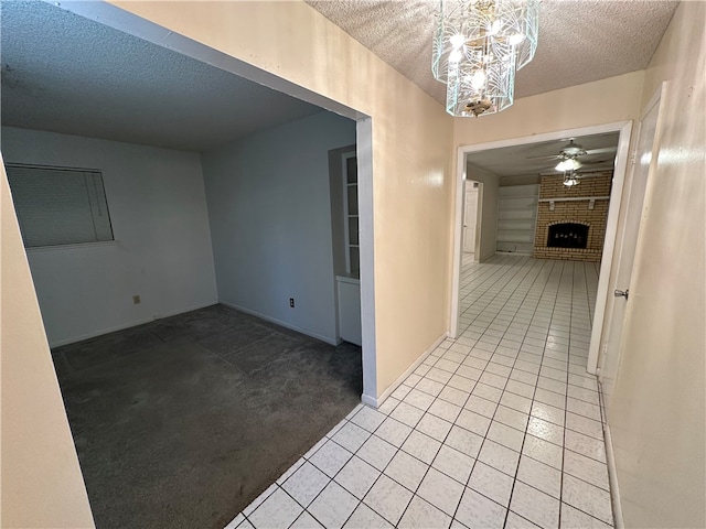 hallway featuring a textured ceiling, light carpet, and an inviting chandelier