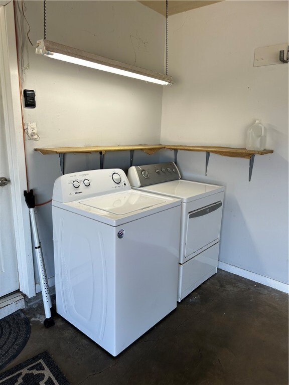 clothes washing area with washer and dryer