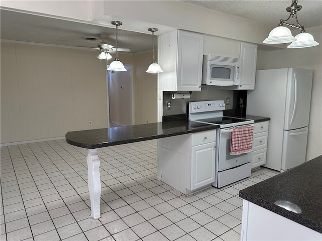 kitchen featuring white cabinets, kitchen peninsula, decorative light fixtures, and white appliances