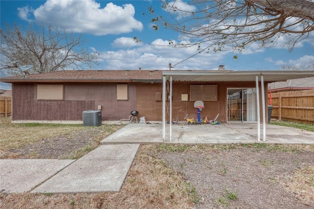 rear view of house with central air condition unit and a patio