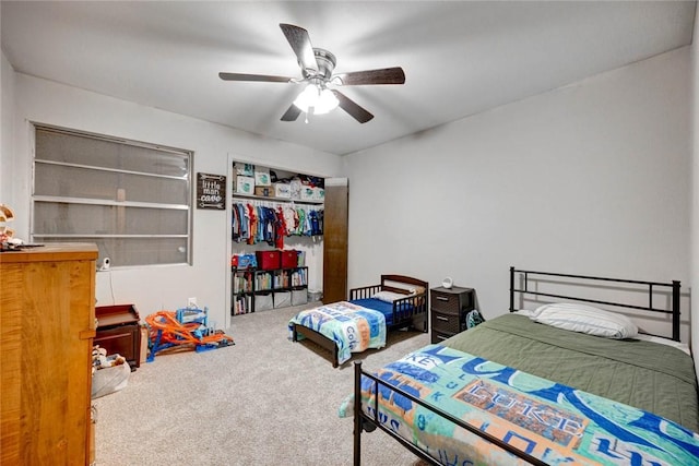 bedroom with carpet, a closet, and ceiling fan