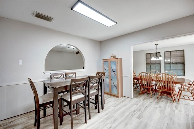 dining room with a notable chandelier and light hardwood / wood-style floors