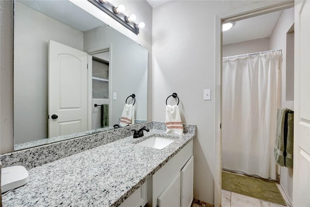 bathroom with tile patterned floors and vanity