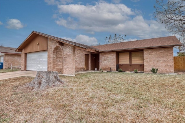 ranch-style house featuring a garage and a front yard