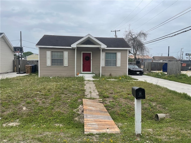 bungalow-style home with a front yard