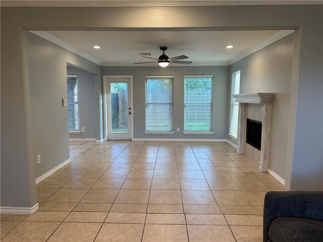 unfurnished living room featuring ornamental molding, light tile patterned floors, ceiling fan, and a fireplace