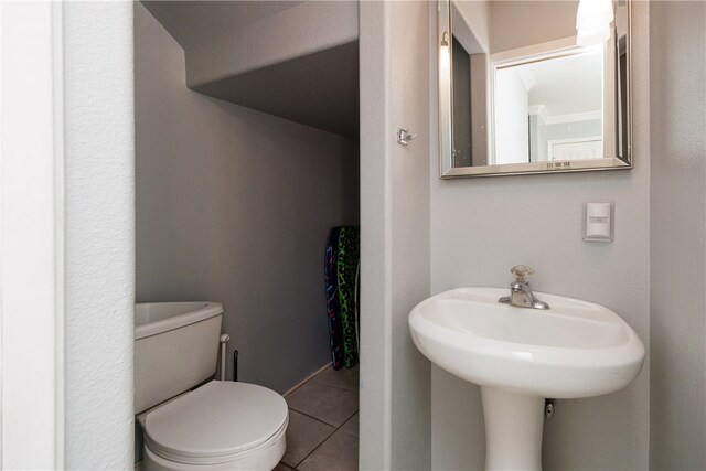 bathroom featuring toilet and tile patterned floors