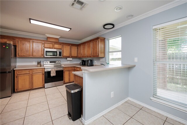 kitchen with kitchen peninsula, light tile patterned flooring, appliances with stainless steel finishes, and ornamental molding