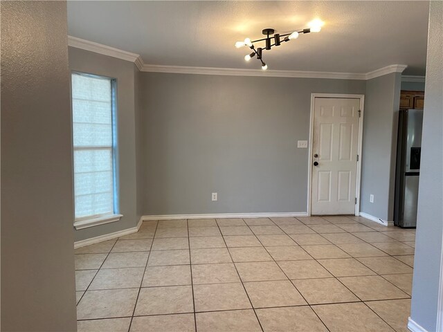 unfurnished room featuring light tile patterned flooring and crown molding