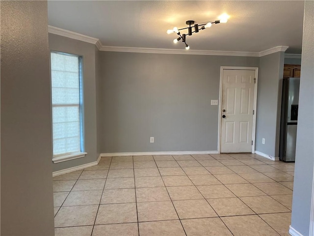 2626 Wool Dr, Corpus Christi, TX 78414 - empty room featuring light tile patterned floors, ornamental molding, baseboards, and a chandelier