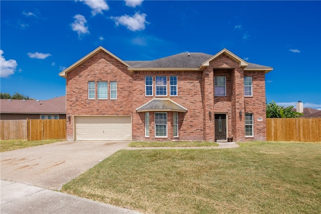 view of front of home featuring a garage and a front yard