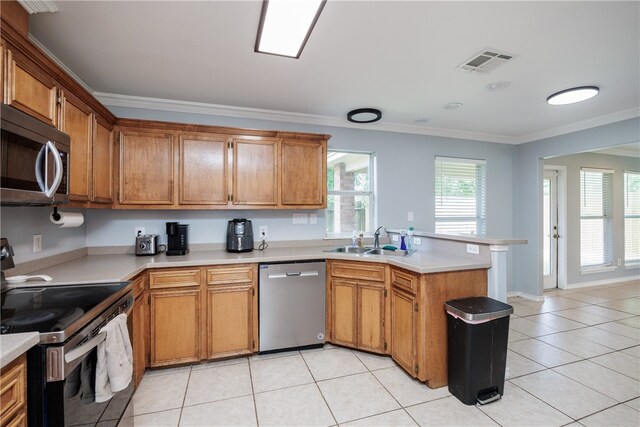 kitchen featuring stainless steel appliances, light tile patterned flooring, kitchen peninsula, and ornamental molding