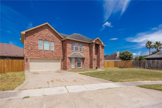 view of property featuring a front yard and a garage