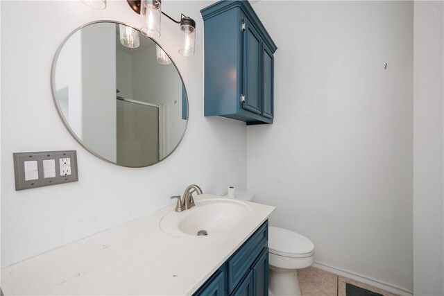 bathroom featuring vanity, walk in shower, tile patterned floors, and toilet