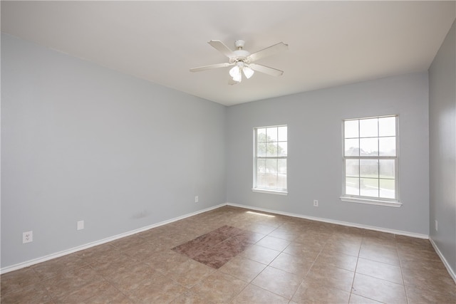 tiled empty room with ceiling fan