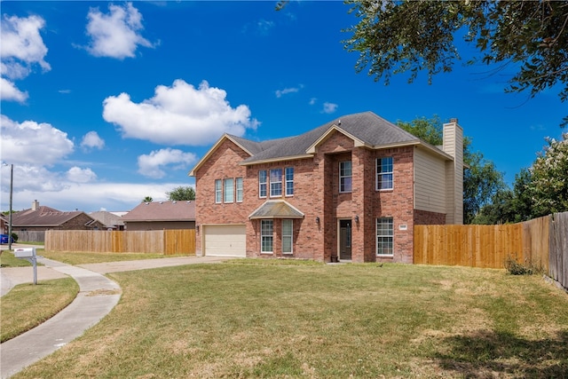 view of front of property featuring a front yard and a garage