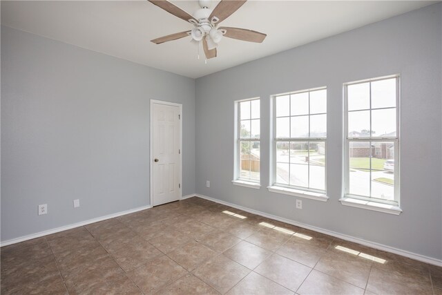 spare room with tile patterned flooring and ceiling fan