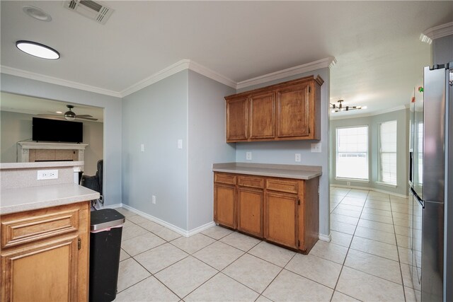 kitchen featuring ceiling fan, stainless steel fridge with ice dispenser, light tile patterned floors, and ornamental molding