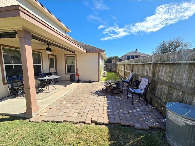 view of patio / terrace with ceiling fan and a fire pit