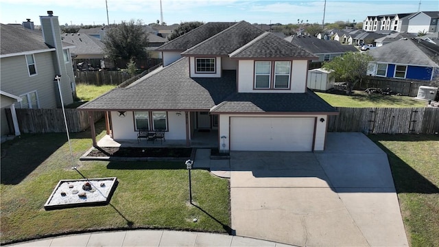 view of front of home featuring a garage, a front yard, and a patio