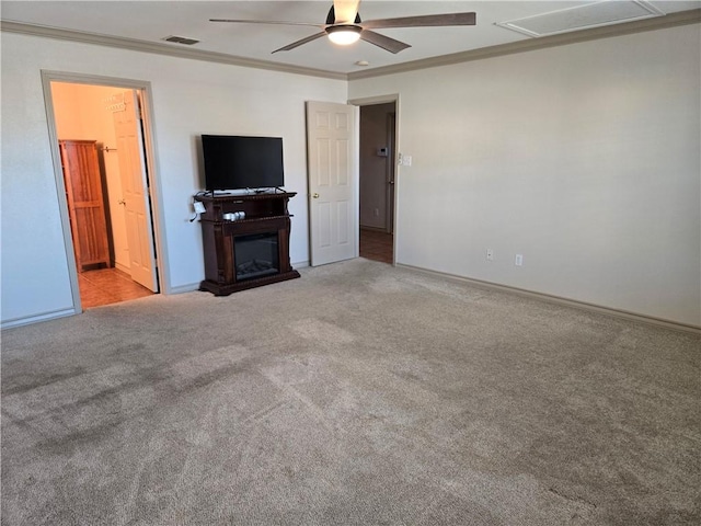 unfurnished living room featuring ceiling fan, crown molding, and light colored carpet