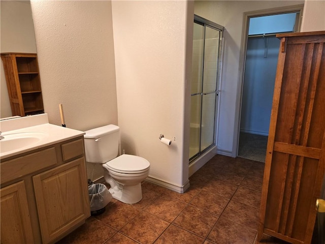 bathroom with vanity, toilet, and an enclosed shower