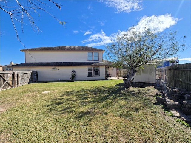 rear view of house with a yard