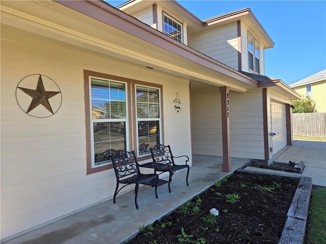 view of patio / terrace with covered porch and a garage