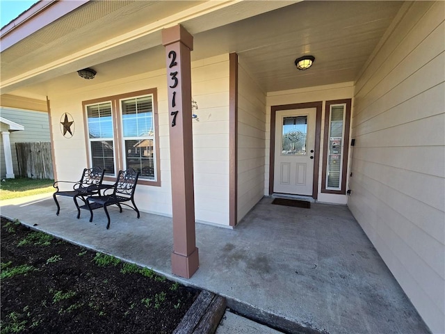 view of exterior entry with covered porch